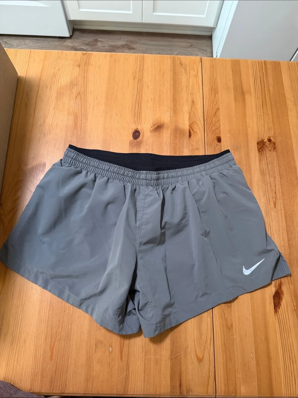 Nike Gray Athletic Shorts with Black Waistband and White Swoosh